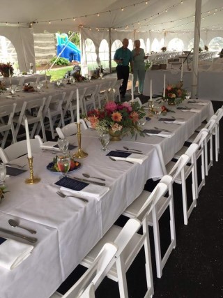 Wedding Reception - 40' x 80' Tent, White Padded Chairs, Rectangular Tables with White Linens, Cathedral Sidewalls, Tent Lights, Centerpieces.