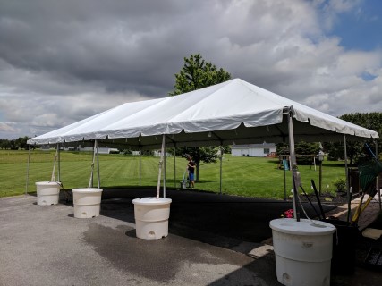 Graduation Party - 20' x 40' Frame Tent (Free Span) on Driveway. One side anchored with Water Barrels.