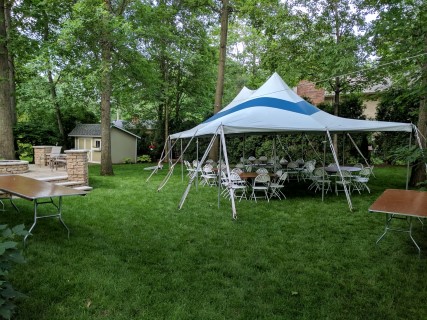 Graduation Party - 20' x 30' Tent with Blue Stripe, Rectangular Buffet Tables, Round Tables, White Steel/Plastic Fanback Chairs.