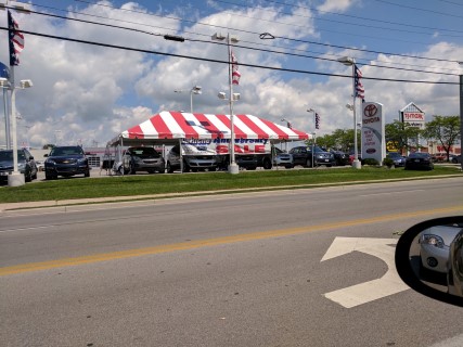 Parking Lot Sale at Auto Dealership - 20' x 40' Red and White Striped Tent, Free Span.