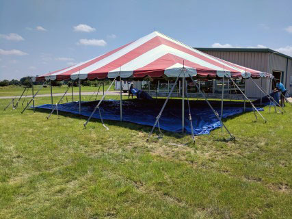 Car Show - 40' x 40' Red and White Striped Carnival Style Tent. We use drop cloths (tarps) to protect the tent canopy during installation.