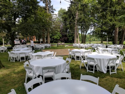 White Padded Chairs, 60" Round Tables, Linens, Dance Floor.