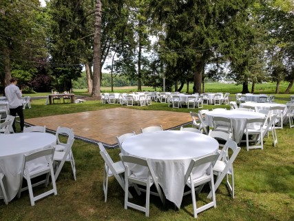 White Padded Chairs, 60" Round Tables, Linens, Dance Floor.