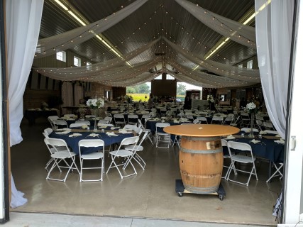 Stables Wedding Reception - White Steel/Plastic Chairs, Round Tables, Linens, Lighting, Barrel, Centerpieces.
