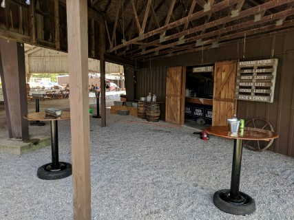 Rustic Pavilion Wedding Reception - Round and Rectangular Tables, Bistro Tables, Wooden Chairs, Hay Bales, Wagon Wheel, Pallet.