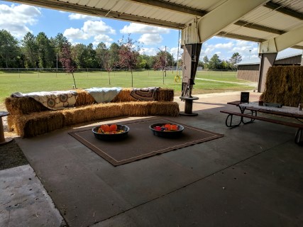 Rustic Pavilion Wedding Reception - Round and Rectangular Tables, Wooden Chairs, Hay Bales, Picnic Tables, Children's Play Area.