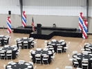 60" Round Tables, White Plastic Chairs, Riser Staging, PA System with Podium.